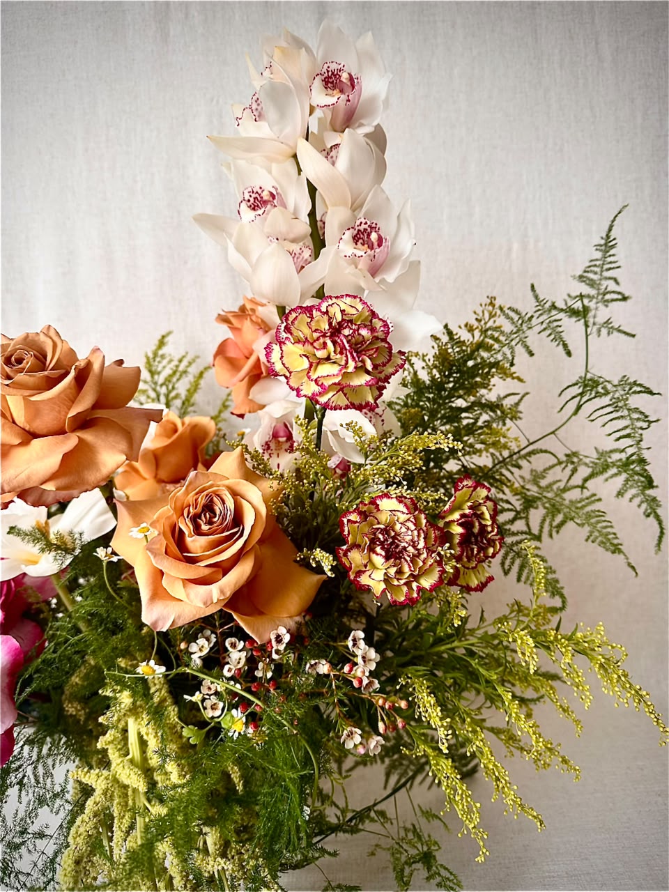 Overhead view of a single pink-striped parrot tulip in a clear vase